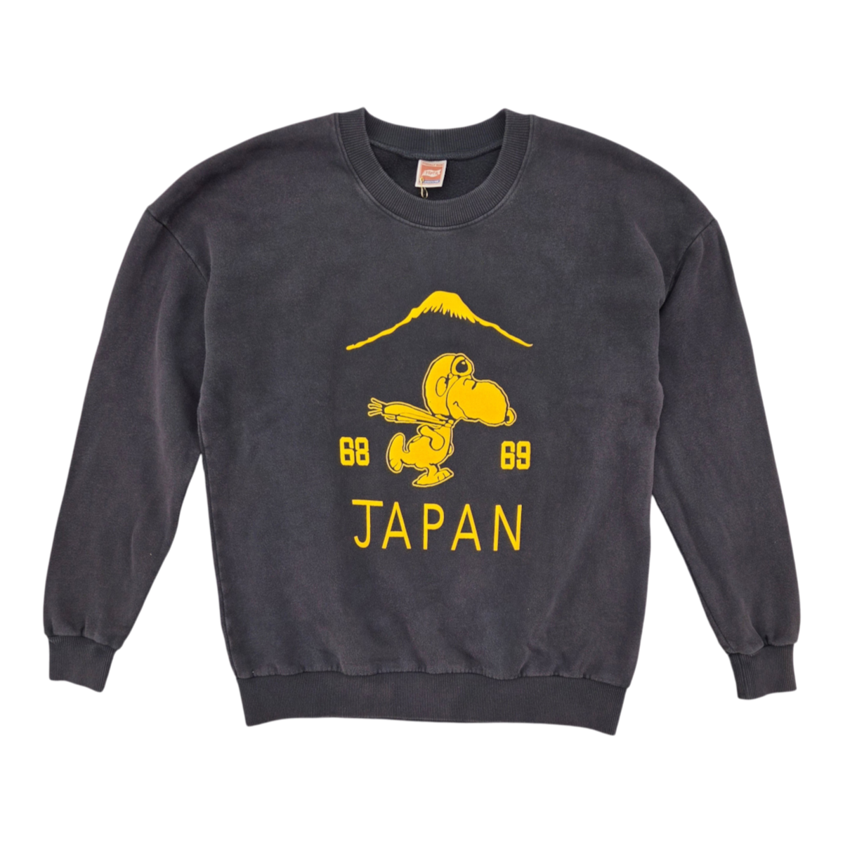 MILWORKS Suka Snoopy sweatshirt in vintage black with a yellow graphic of Snoopy, Mount Fuji, and Japan text.