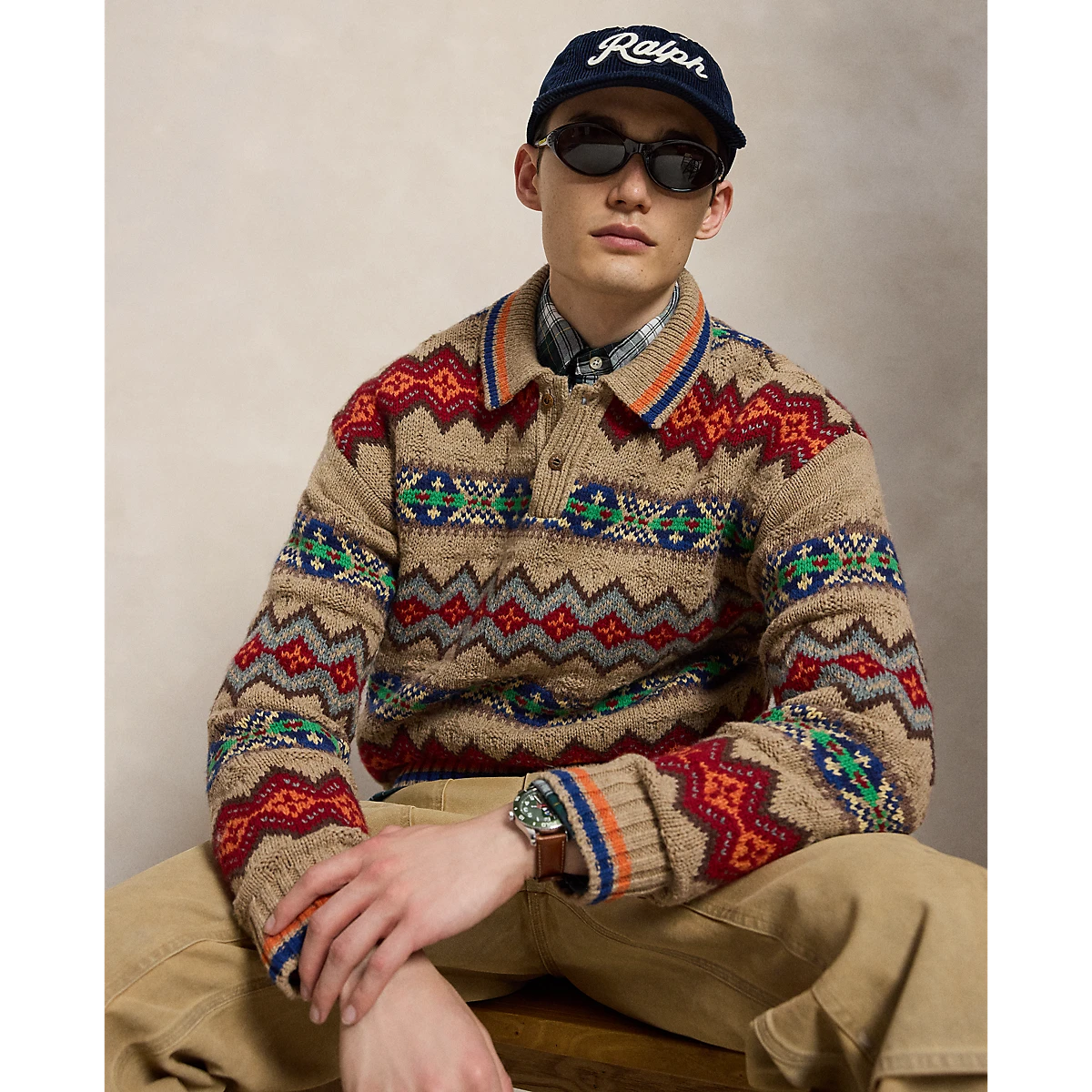 MILWORKS model wearing a tan Polo Ralph Lauren Fair Isle sweater polo with a vibrant geometric pattern
