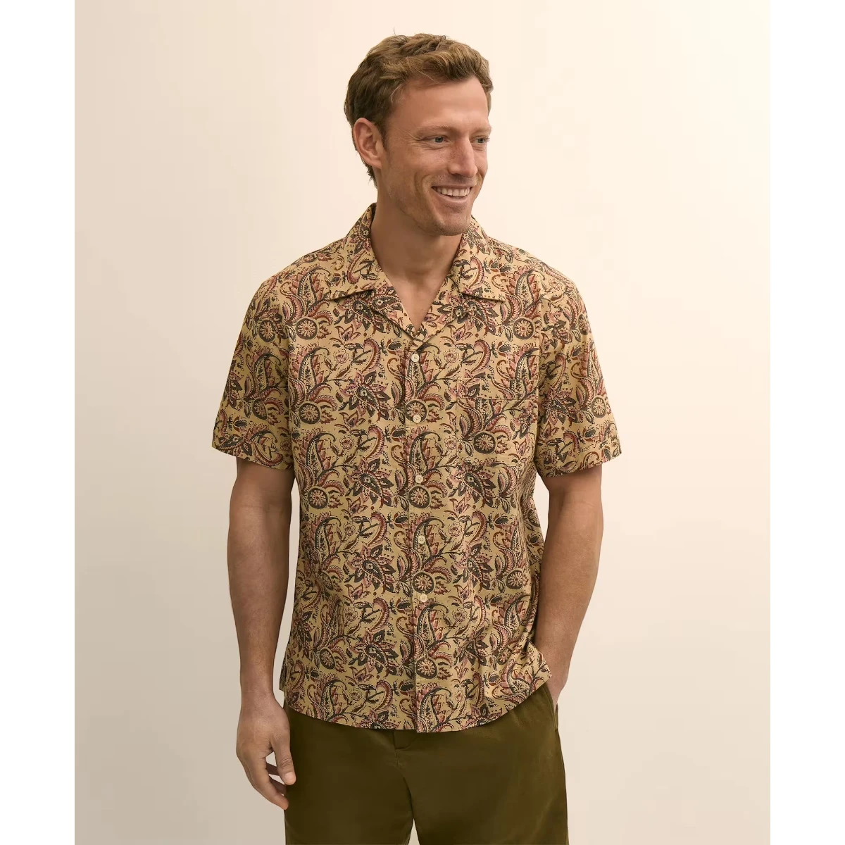 MILWORKS men's short-sleeve camp collar shirt in tan with a red and black paisley block print. 100% cotton.