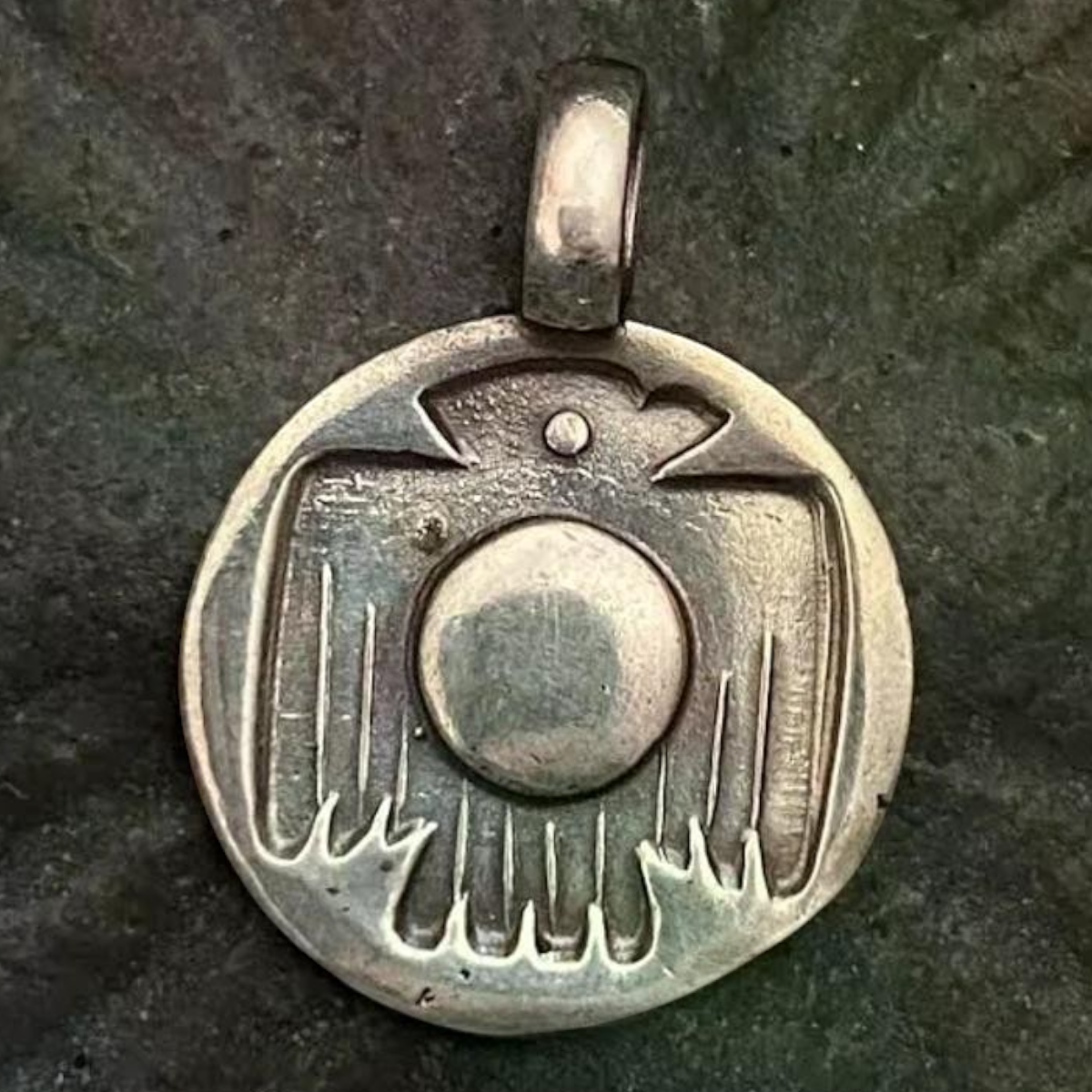 MILWORKS Solid Thunderbird charm featuring a detailed stamped design on a circular silver pendant.