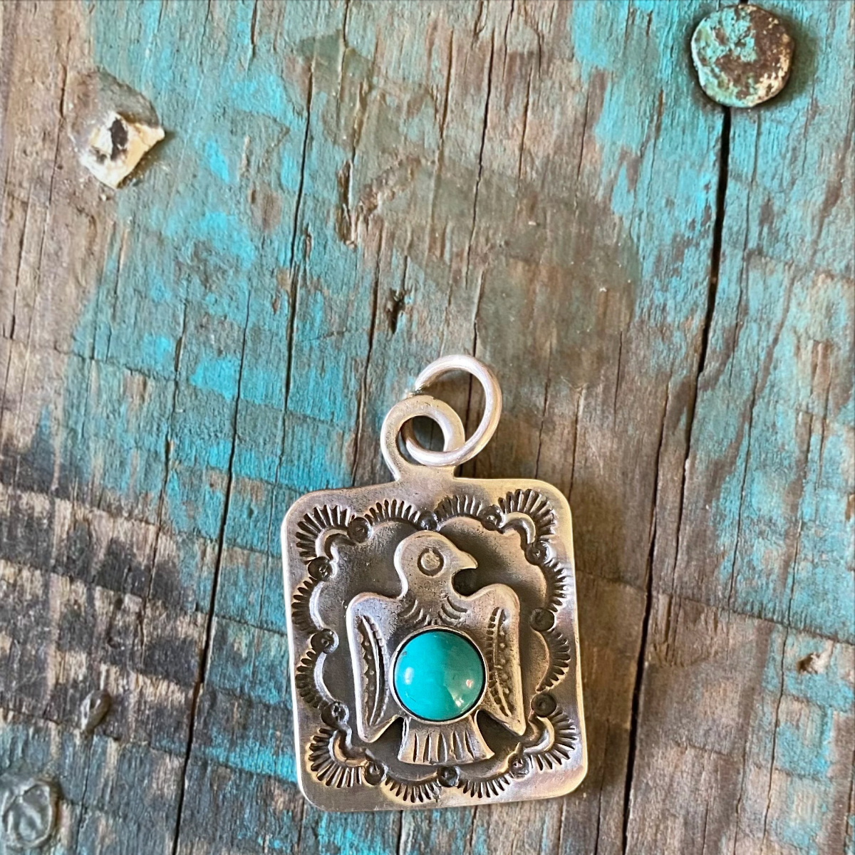 MILWORKS sterling silver dog tag pendant featuring a Thunderbird design with a central turquoise stone