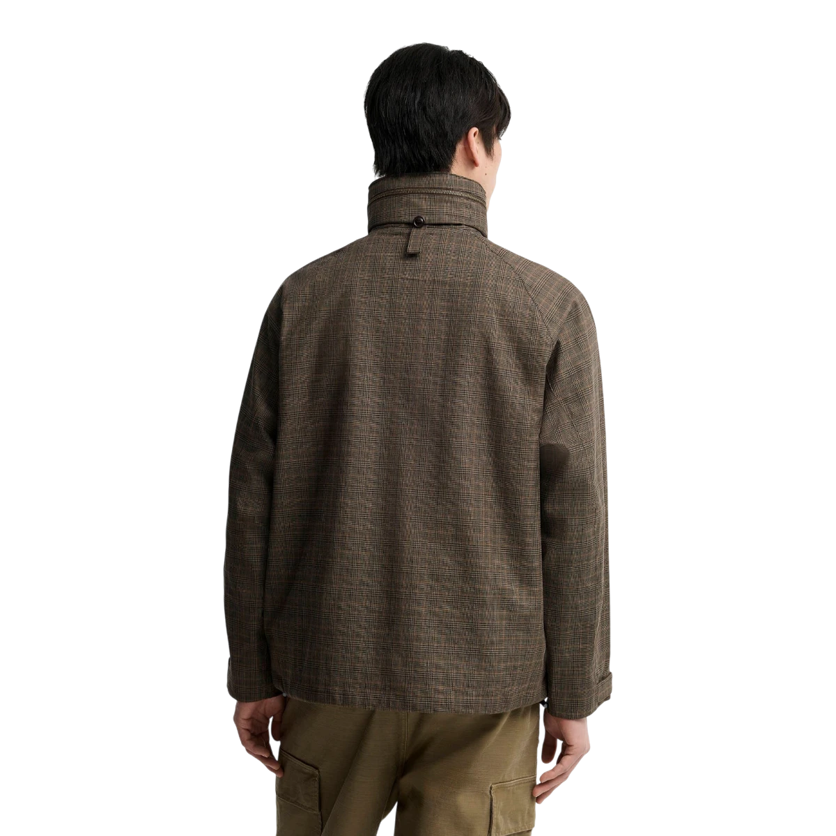 Back view of a man wearing a MILWORKS Transport Ursula waterproof jacket in dark stone check pattern with stand collar.