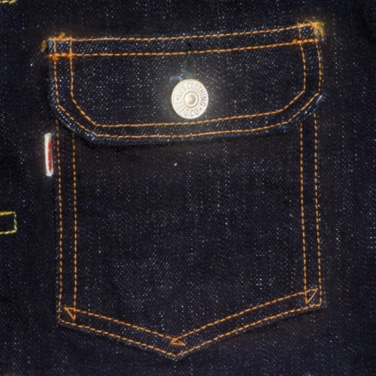 MILWORKS UES 17oz denim jacket chest pocket detail with contrast stitching and branded metal button