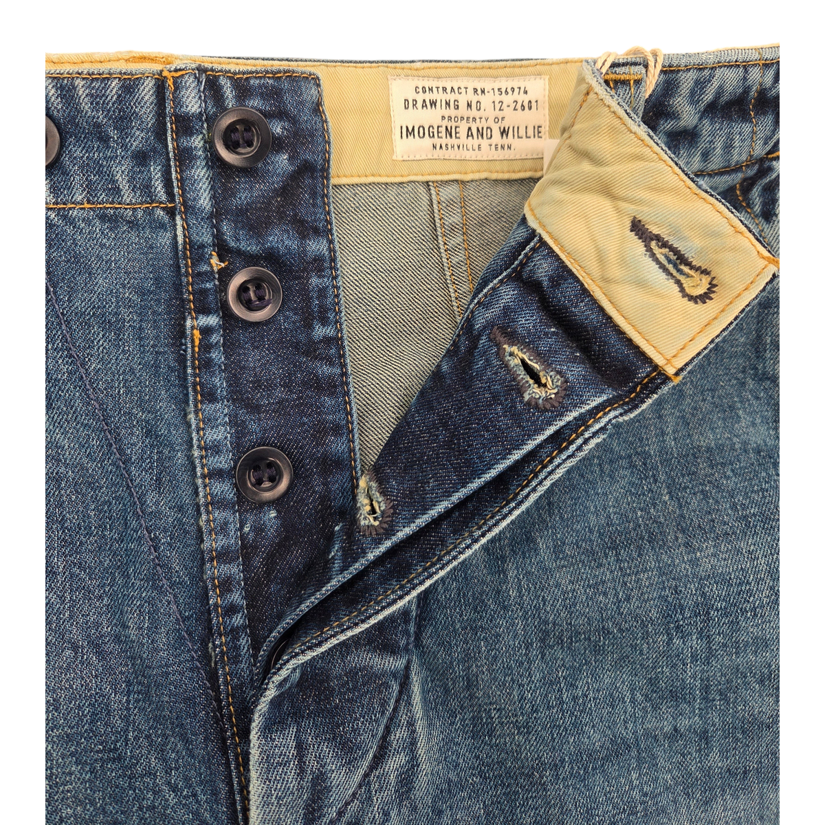 MILWORKS washed denim carpenter pants featuring a double-button closure and interior brand label detail.