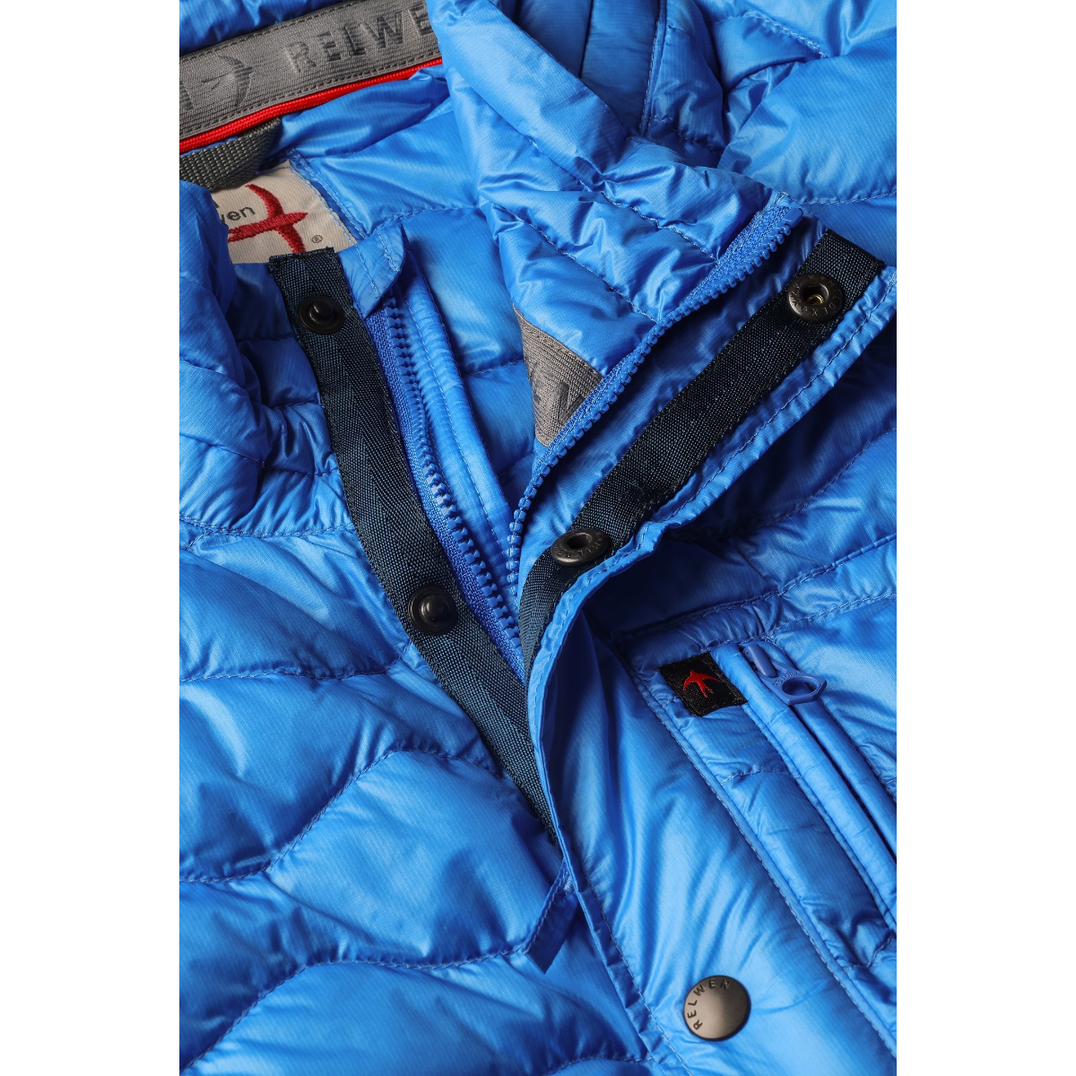 Milworks bright cobalt blue wave-quilt down jacket with snap buttons, zipper closure, and chest pocket detail.