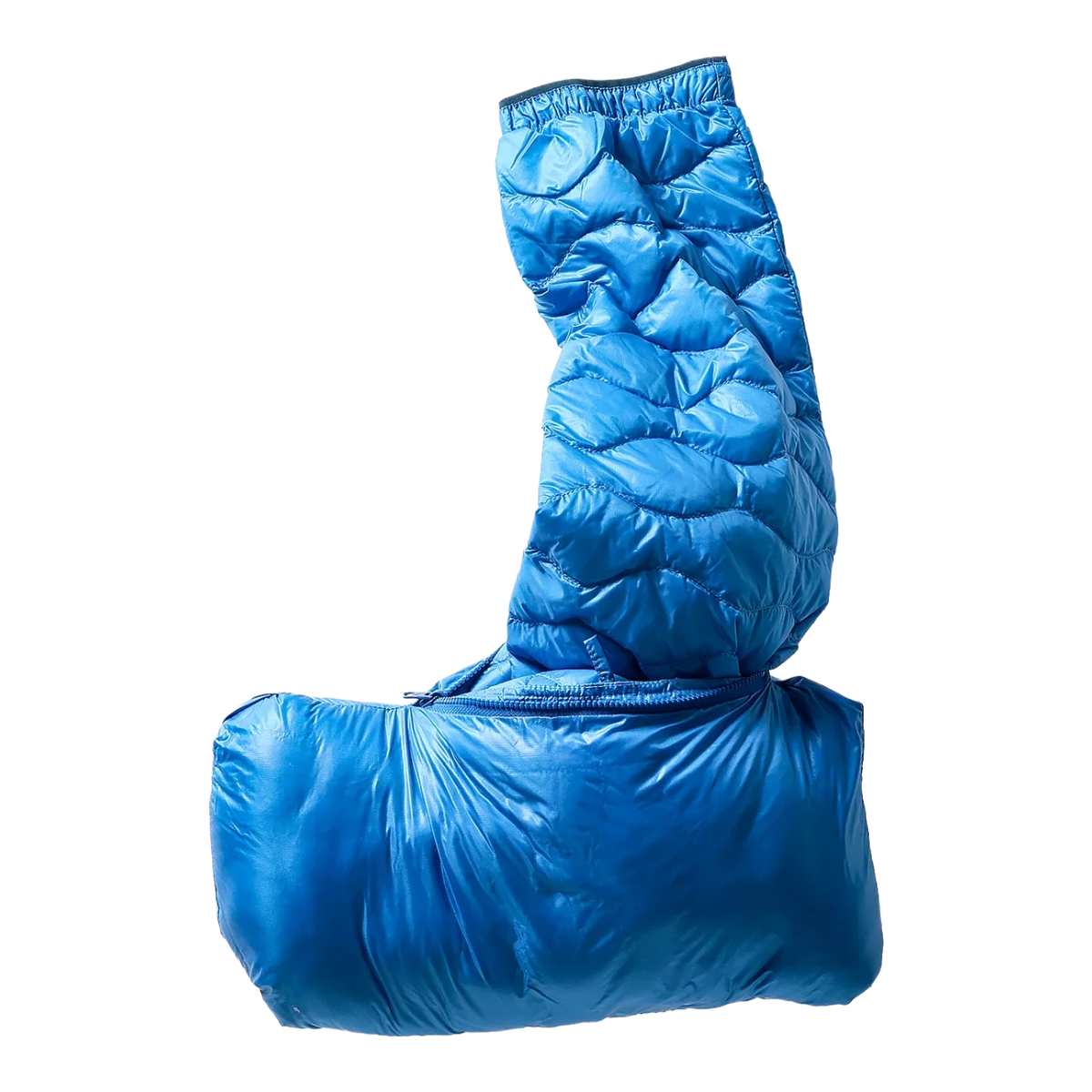 Milworks bright cobalt blue wave-quilt down jacket partially packed into its own pocket for travel.