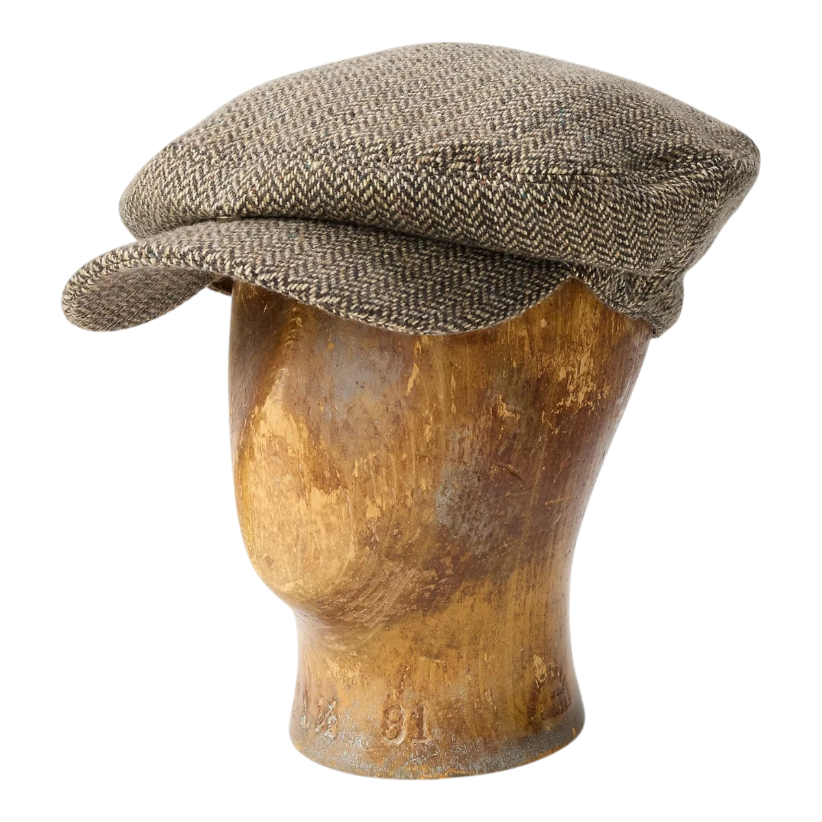 MILWORKS wool-blend herringbone driver's cap in cream and brown with a snap-down brim on a wooden mannequin head.