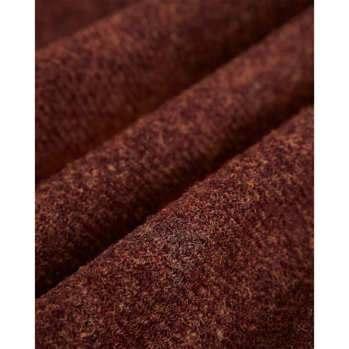 Close-up of MILWORKS Wool Field Overshirt in a rich, textured dark burgundy wool fabric with visible weave detail.