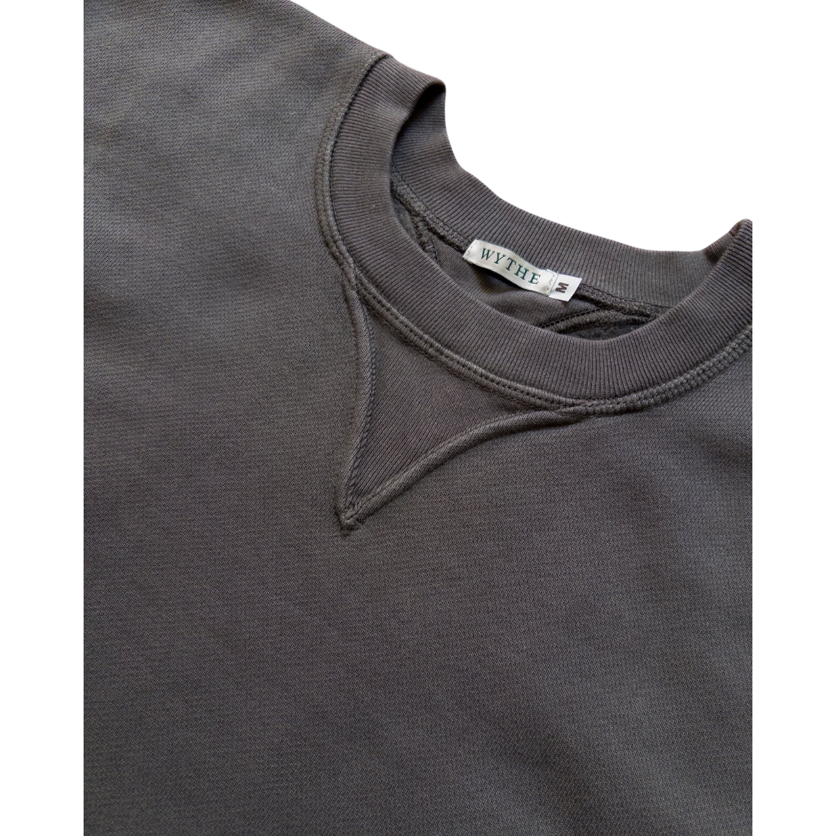 MILWORKS Wythe faded black cotton crewneck sweatshirt featuring a ribbed neckline and signature V-shaped insert