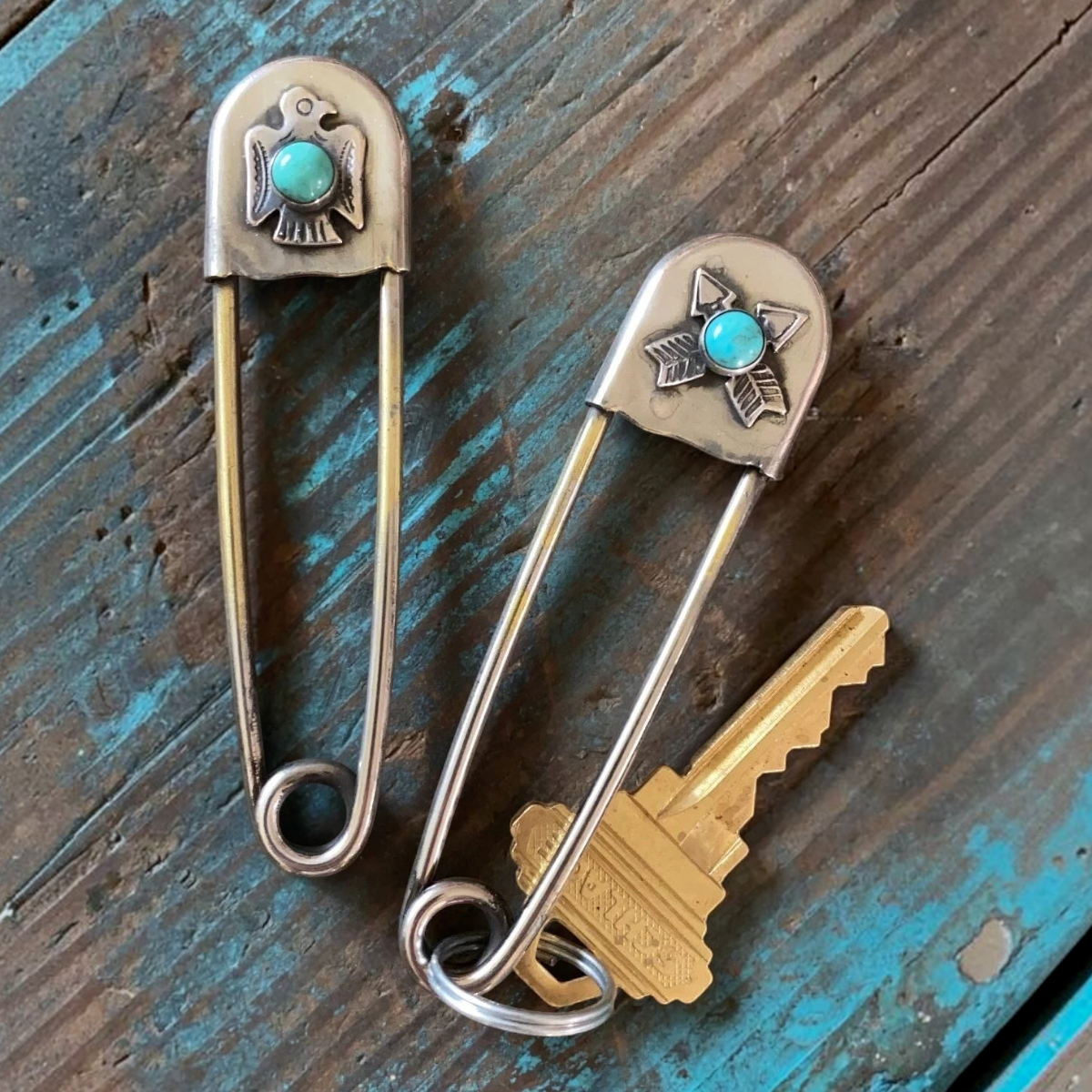 MILWORKS XL safety pin keychains in nickel silver with sterling silver thunderbird, crossed arrows, and turquoise.