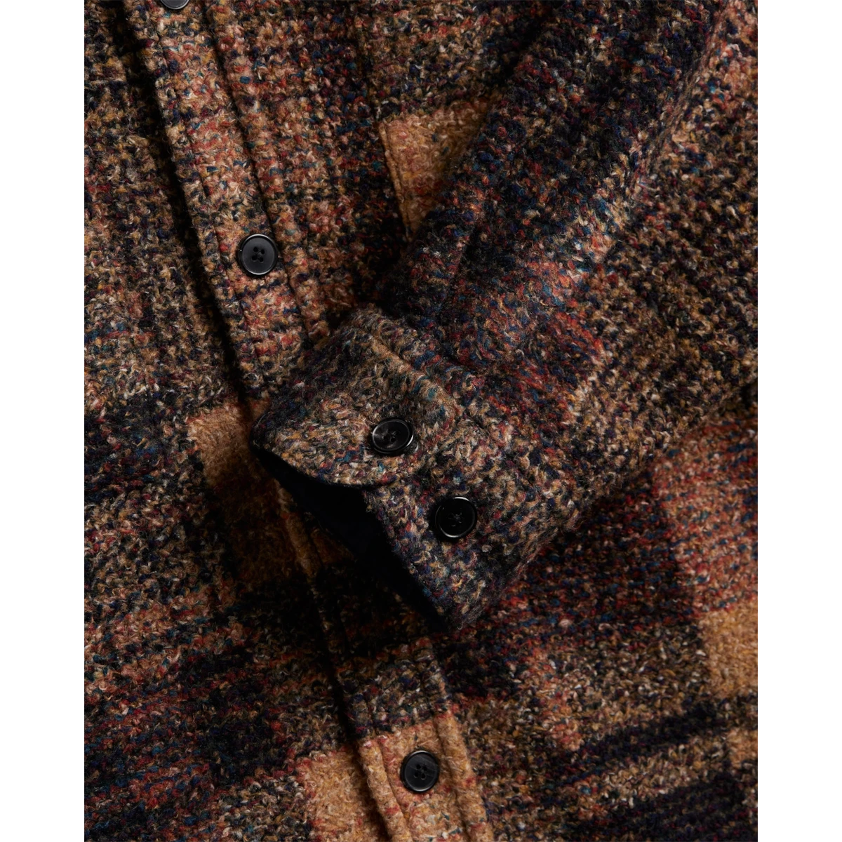 MILWORKS Zender wool plaid shirt featuring a textured brown and multi-colored pattern with black resin buttons
