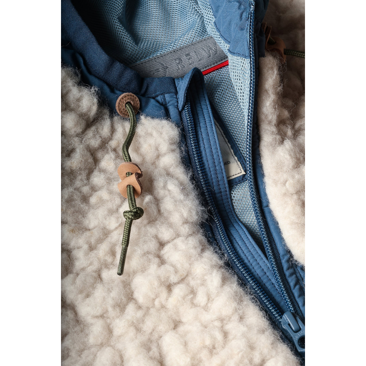 Relwen Abominable Hood jacket in natural wool-blend sherpa pile with blue nylon trim and leather drawcord details.